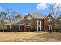 Charming two-story brick home features a well-manicured lawn and mature landscaping at 2331 Rabbit Farm Cir, Loganville, GA 30052