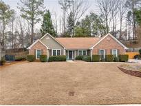 Charming brick and siding home with a manicured lawn and mature landscaping at 2895 Dogwood Creek Pkwy, Duluth, GA 30096