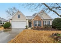 Charming single-Gathering home featuring a stone-accented facade, attached garage and well-maintained landscaping at 6745 Waveland Dr, Cumming, GA 30040