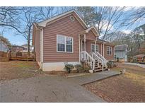 Charming home featuring a wood facade, a welcoming front porch, and a well-maintained front yard at 2024 Collier W Cir, Decatur, GA 30032