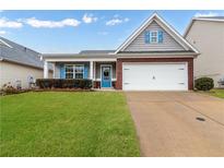 Charming single-story home featuring a well-maintained lawn, a two-car garage, and decorative blue shutters at 521 Gardenview Rd, Canton, GA 30114