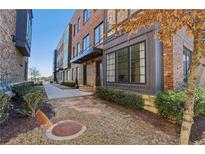 Modern brick townhome with landscaped front yard and stylish architectural details at 264 Castleberry Station Sw Dr, Atlanta, GA 30313
