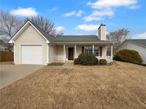 Charming single-story home with a cozy front porch and attached garage at 328 Village Ln, Stockbridge, GA 30281