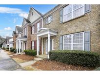 Charming townhomes feature brick exteriors, inviting front porches, and well-maintained landscaping at 4878 Hairston Park Sq, Stone Mountain, GA 30083