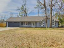 Charming single-story home with a front porch and a two-car garage in a quiet neighborhood at 701 Jefferson Drive, Conyers, GA 30014