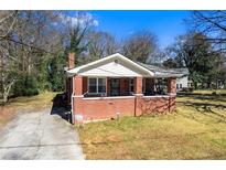 Charming brick home featuring a cozy front porch and well-maintained yard, perfect for suburban living at 2163 Ben Hill Rd, Atlanta, GA 30344