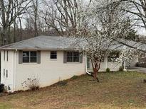 Charming brick home with blooming tree, offering a peaceful and inviting curb appeal at 184 Wana Se Cir, Mableton, GA 30126