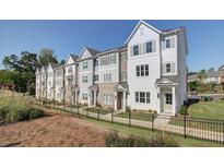 View of new townhomes featuring modern architectural details and well-maintained landscaping at 3316 Cranston Ln, Kennesaw, GA 30144