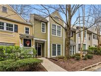Charming townhouse featuring a well-maintained exterior and inviting front walkway to the covered front porch at 5065 Avalon Dr, Alpharetta, GA 30005