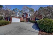 Charming brick home with a well-manicured lawn and attached two-car garage at 4927 Pembridge Nw Ln, Kennesaw, GA 30144