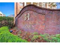 A beautiful brick sign with a logo marks the entrance to Heritage Place Condominium Community at 211 Colonial Homes Nw Dr # 1303, Atlanta, GA 30309