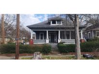 Charming two-story home with a screened-in porch and landscaped front yard at 540 Langhorn Sw St, Atlanta, GA 30310