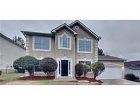 Charming two-story home features a well-manicured lawn and a classic stucco exterior at 805 Kilkenny Cir, Lithonia, GA 30058