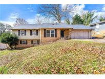 Charming split-level home with a brick and siding exterior and an attached two-car garage at 2671 Lee Ann Dr, Marietta, GA 30066