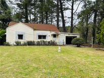 Charming single-Gathering home with a spacious front yard and attached garage at 1821 Lomita Se Rd, Atlanta, GA 30316