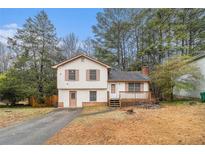 Charming home featuring a front porch and cozy design, set amongst mature trees and a well-maintained lawn at 2169 Tiffany Ln, Lithonia, GA 30058