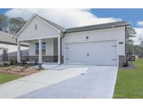 Charming single-story home with a two-car garage and professionally landscaped front yard at 3614 Arrow Root Cir, Loganville, GA 30052