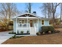 Charming bungalow featuring a welcoming front porch and a freshly landscaped yard and new walkway at 1020 Pinedale Se Dr, Smyrna, GA 30080