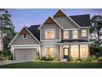 Charming two-story home boasts craftsman-style details, neutral tones, and lush front lawn at 1605 Wander Ml, Cumming, GA 30040