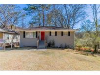 Charming, single-story home with a brick facade, red front door, and well-manicured lawn at 2202 Polar Rock Sw Pl, Atlanta, GA 30315