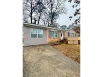 Charming single-story home with a brick facade and a concrete driveway at 172 Scarsdale Dr, Riverdale, GA 30274