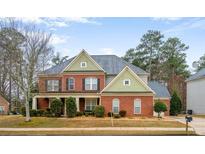 Charming two-story brick home with a well-manicured lawn and inviting curb appeal at 3162 Abbey Sw Dr, Atlanta, GA 30331