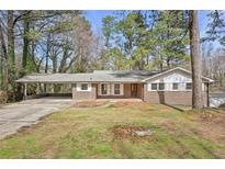 Charming brick home featuring a covered carport and a well-maintained front yard at 3339 Brenda Ln, Lithia Springs, GA 30122