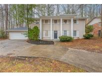 Charming two-story home with a classic facade, a large driveway, and a well-manicured lawn at 2800 Kingston Ter, Atlanta, GA 30344