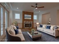 Bright living room features fireplace, hardwood floors, ceiling fan and two sofas at 3007 Holly St, Canton, GA 30115