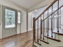 Inviting foyer with leaded glass door and beautiful hardwood floors and staircase at 633 Butterworth Rd, Canton, GA 30114