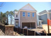Two story brick house with a front facing garage and white trim under construction at 1985 William Glen St, Dacula, GA 30019