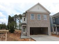 Two-story home featuring a spacious two-car garage and brick and siding accents at 1985 William Glen St, Dacula, GA 30019