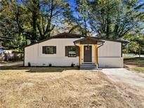 Charming renovated home with a covered front entry and a freshly landscaped yard at 2038 Rosewood Rd, Decatur, GA 30032