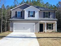 Charming two-story home features a two-car garage and a well-manicured front lawn at 15 Barton Lane, Covington, GA 30016