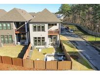Inviting backyard featuring a patio, landscaping, and privacy fence at 158 Village Green Ave, Woodstock, GA 30189