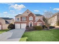 Charming two-story brick home with a well-manicured lawn and attached two-car garage at 5466 Vinings Lake Way, Mableton, GA 30126