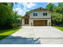 Beautifully landscaped home boasts a modern facade, stone accents, and a spacious driveway at 2116 Strasburg Ct, Dunwoody, GA 30338