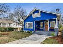 Charming blue two-story home with inviting front porch and well-maintained landscaping at 726 Brookline Sw St, Atlanta, GA 30310