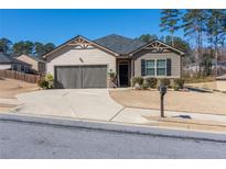 Charming single-Gathering home with a two car garage and well-manicured lawn at 8125 Berrywood Se Ct, Covington, GA 30014