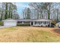 Charming single-story home with gray painted brick and a well-maintained front yard at 3368 Windsor Castle Ct, Decatur, GA 30034