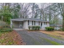 Charming single-story home with brick facade, black shutters, and a covered carport at 2024 Rosewood Rd, Decatur, GA 30032