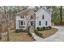 Charming two-story traditional home featuring a well-manicured front yard and a welcoming entrance at 3938 Belle Glade Ct, Snellville, GA 30039