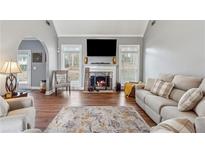Inviting living room featuring a cozy fireplace, vaulted ceiling, and neutral decor for a relaxing atmosphere at 3207 Haleys Way, Conyers, GA 30013