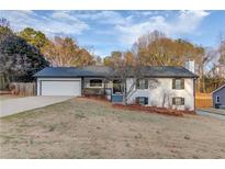 Charming one-story home with a well-maintained lawn and attached two-car garage at 3625 Knoll Crest Trl, Buford, GA 30519
