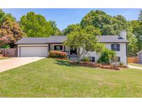 Charming single-story home featuring a lush green lawn and well-maintained landscaping at 3625 Knoll Crest Trl, Buford, GA 30519