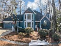 Charming blue two-story home featuring a manicured front yard and a two car garage at 3017 Lana Ln, Marietta, GA 30066