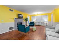 Inviting living room boasts a fireplace, hardwood floors, and lots of natural light at 1203 Gettysburg Pl, Sandy Springs, GA 30350
