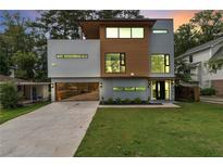 Contemporary home showcasing modern design, wood accents, and a sleek glass garage door at 1653 Wayland Ne Cir, Brookhaven, GA 30319