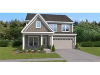 Two-story home featuring gray siding, a two-car garage and professionally landscaped yard at 428 Madison Lakeview Dr, Acworth, GA 30102