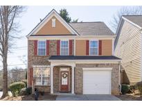 Charming two-story home featuring brick and siding, attached garage, and a welcoming front porch at 1514 Park Grove Dr, Lawrenceville, GA 30046